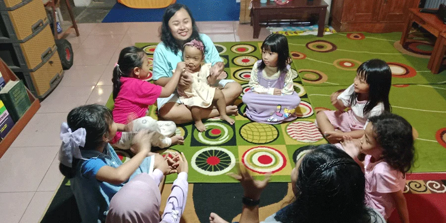 With a fellow teacher and the children in my small home-based learning group in Yogyakarta—a cozy and meaningful time of learning together.