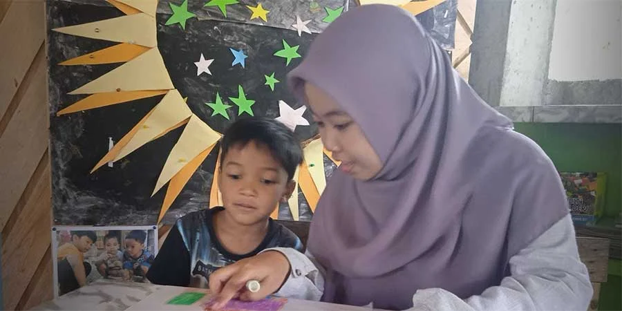 My photo with one of the students at PAUD Joglo. This is when the journal is finished; Children tell stories about what is illustrated in their journals and are then helped to provide captions in their journals. This photo was taken on January 11, 2024 by Nanik at PAUD Joglo.