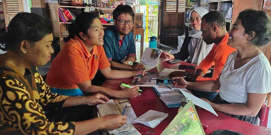 Selly and Sint from West Papua right working with the teacher at Joglo Preschool, September 2022